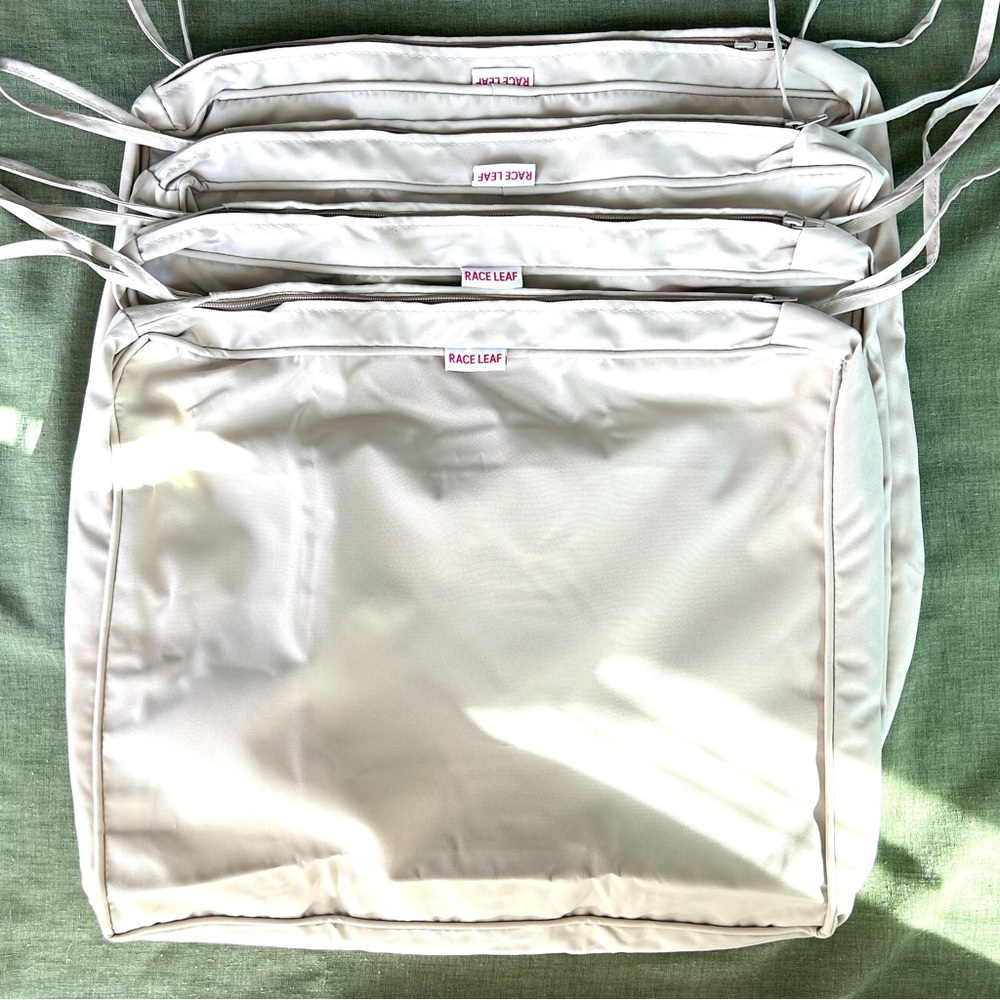 (4) lt. beige outdoor chair cushion covers brand new/ never used/ excellent